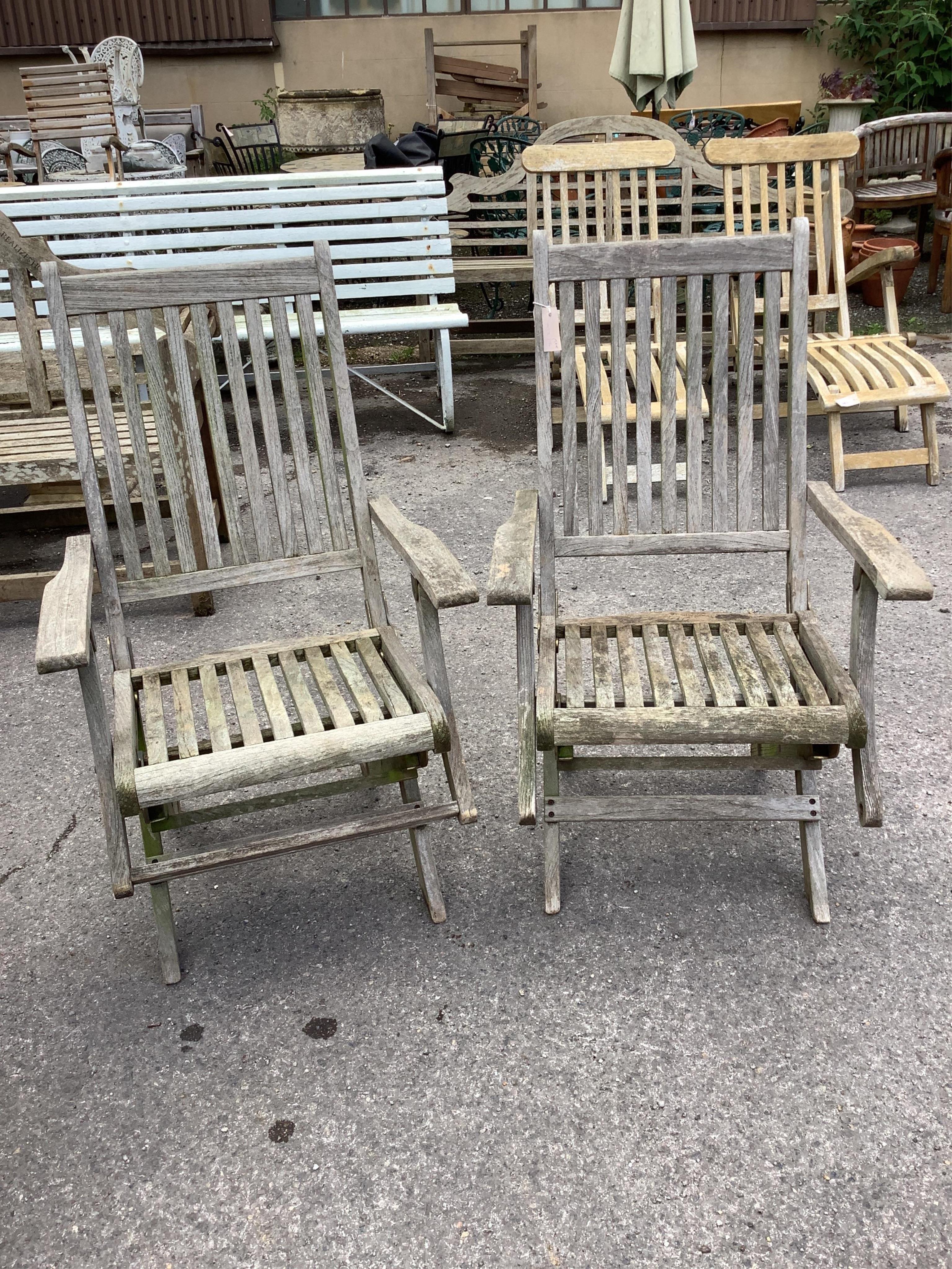 A weathered teak rectangular folding garden table, width 157cm and four folding chairs